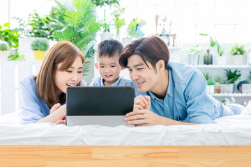 Fototapeta na wymiar Parent play with child by tablet