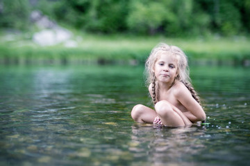 Little girl is swimming in the lake