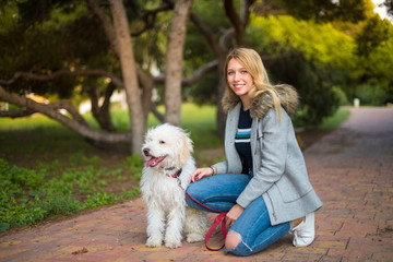 Young girl with her dog in a park