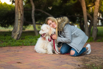 Young girl with her dog in a park