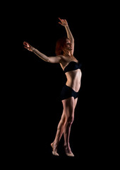 Redhead Girl doing ballet in studio