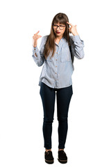 Full-length shot of Woman with glasses making the gesture of madness putting finger on the head