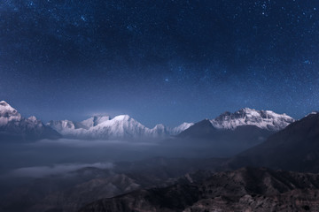 Fototapeta na wymiar Beautiful panoramic view of the night sky over the Annapurna mountain range in the Upper Mustang, Nepal.
