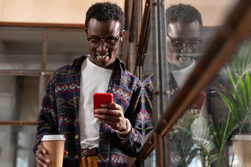 Smiling man concentrated on his texting conversation