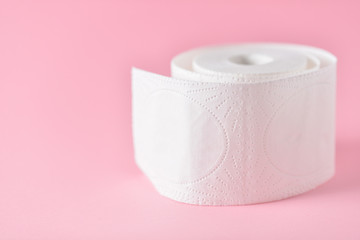 block of white toilet paper on pink background