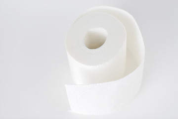 roll of white toilet paper on white background
