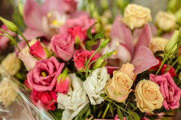 Bouquet with orchids and roses on a beautiful background