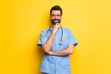 Surgeon doctor man smiling and looking to the front with confident face