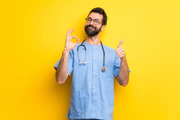 Surgeon doctor man showing ok sign with and giving a thumb up gesture