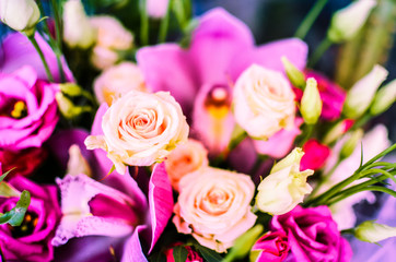 Bouquet with orchids and roses on a beautiful background