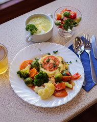 chop with vegetables and juice in a cafe