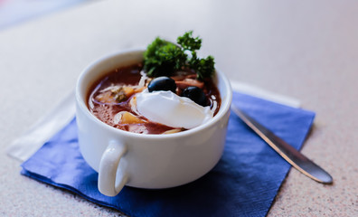 borsch (Russian soup) with sour cream and herbs