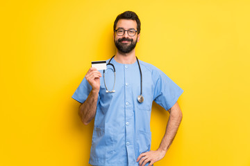 Surgeon doctor man holding a credit card