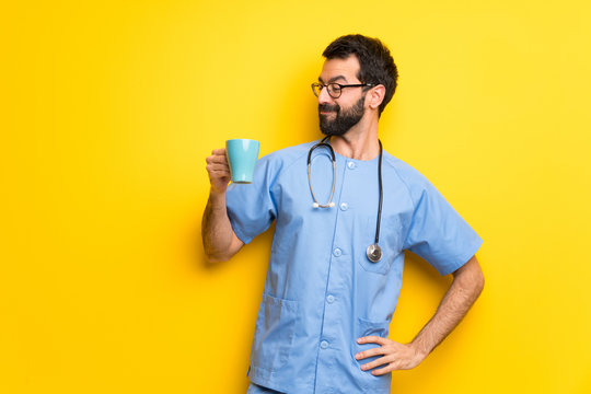 Surgeon Doctor Man Holding A Hot Cup Of Coffee