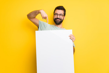 Man with beard and green shirt holding a placard for insert a concept