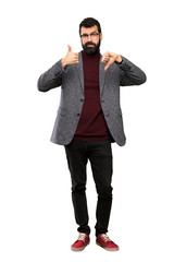 Handsome man with glasses making good-bad sign. Undecided between yes or not over isolated white...