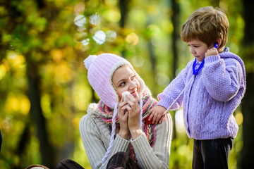 Happy son play with mother like doctor. relax in autumn forest. Spring mood. seasonal cold. Happy family day. Mother love her small boy child. cold weather. Healthy life. Family outdoor. Mothers day