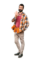 Naklejka premium Craftsmen man happy and counting four with fingers over isolated white background