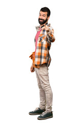 Craftsmen man points finger at you with a confident expression over isolated white background