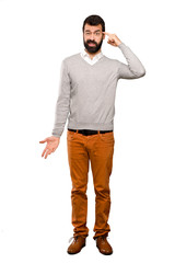 Fototapeta premium Handsome man making the gesture of madness putting finger on the head over isolated white background