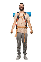 Hiker man shouting to the front with mouth wide open over isolated white background