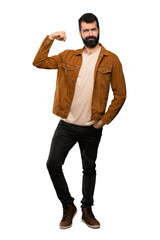 Fototapeta premium Handsome man with beard doing strong gesture over isolated white background