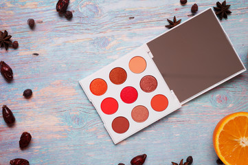 fashion summer eye palettes with  fruit and herbs at blue wooden background. close up