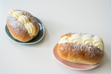 typical Dutch creamed sandwich called roombroodje or puddingbroodje. Against white background