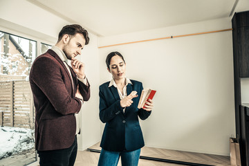 Interior designer giving some advice to owner of the house