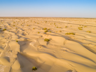 Sundown in desert.Big sand dunes panorama. Desert or beach sand textured background. 