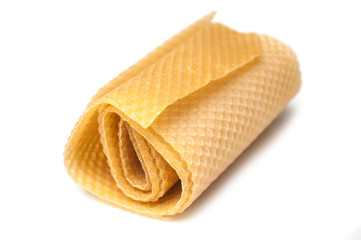 closeup of rolled bees wax on white background