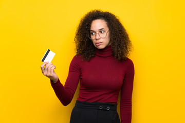 Dominican woman with turtleneck sweater taking a credit card without money
