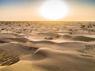 Sundown in desert.Big sand dunes panorama. Desert or beach sand textured background. 
