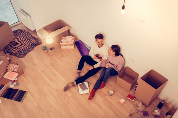 Wife and husband having little romantic dinner in their new house