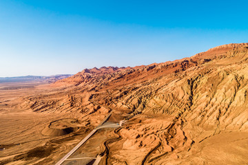 The Flaming Mountains are barren eroded red sandstone hills in Tian Shan Mountain range Xinjiang China. 