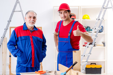 Two professional contractors laying flooring at home