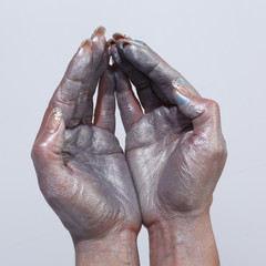 Women's hands in silver paint