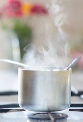 The pot with ran away porridge on the stove