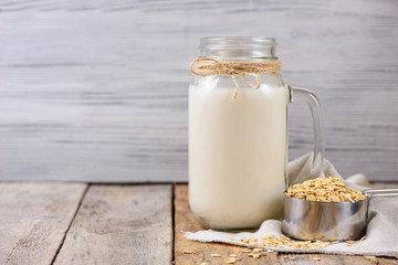 Vegan non dairy  oat milk  in a jar with copy space