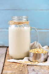 Vegan non dairy  oat milk  in a jar with copy space