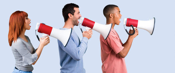 Group of three friends shouting through a megaphone