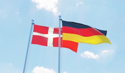 Germany and Denmark, two flags waving against blue sky. 3d image