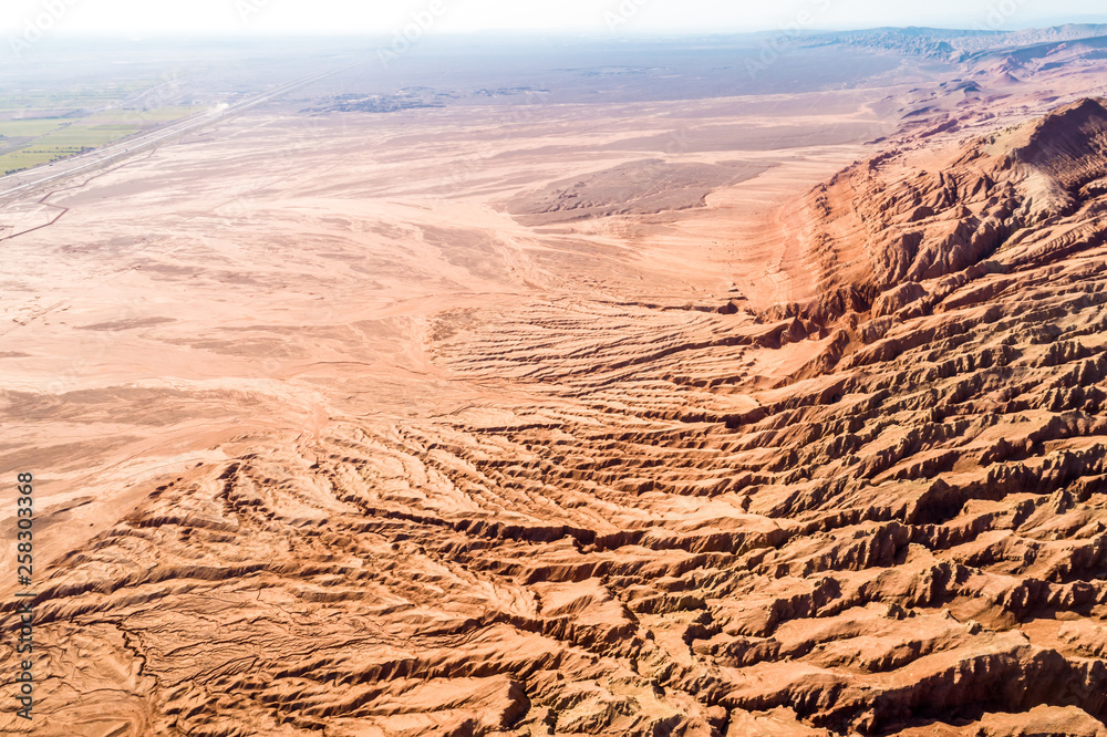 Wall mural The Flaming Mountains are barren eroded red sandstone hills in Tian Shan Mountain range Xinjiang China. 