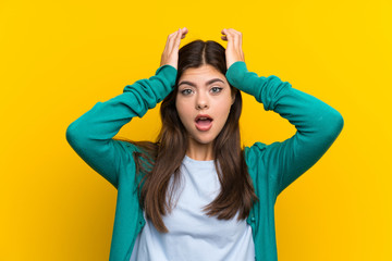 Fototapeta na wymiar Teenager girl over yellow wall with surprise facial expression
