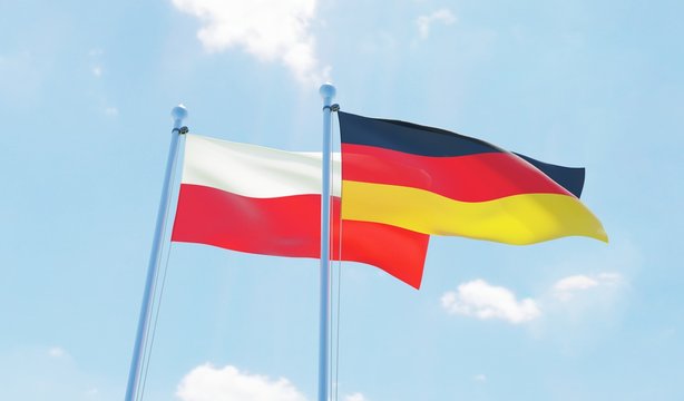 Germany and Poland, two flags waving against blue sky. 3d image