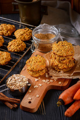 Carrot oatmeal cookies with with cranberries and cinnamon on the rustic background