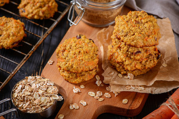 Carrot oatmeal cookies with with cranberries and cinnamon on the rustic background
