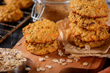 Carrot oatmeal cookies with with cranberries and cinnamon on the rustic background