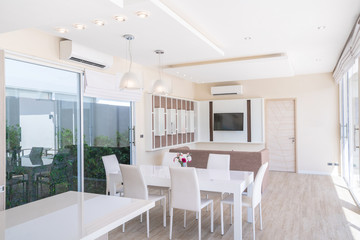 house or home building Luxury interior design in living room of pool villas. Airy and bright space with high raised ceiling and dining table
