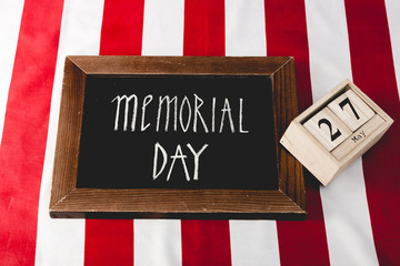 memorial day letters on black board near wooden cubes with date